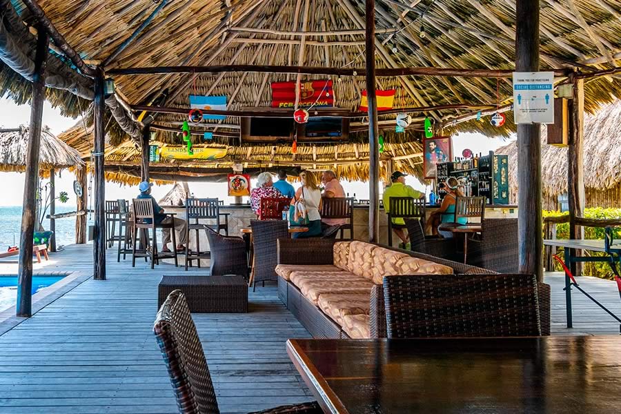 people sitting on stools at Captain Morgan's Retreat Pool Bar