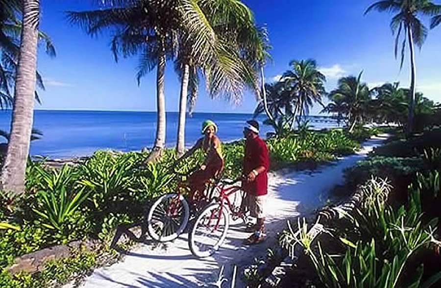 Bicycling along a narrow road in Ambergris Caye