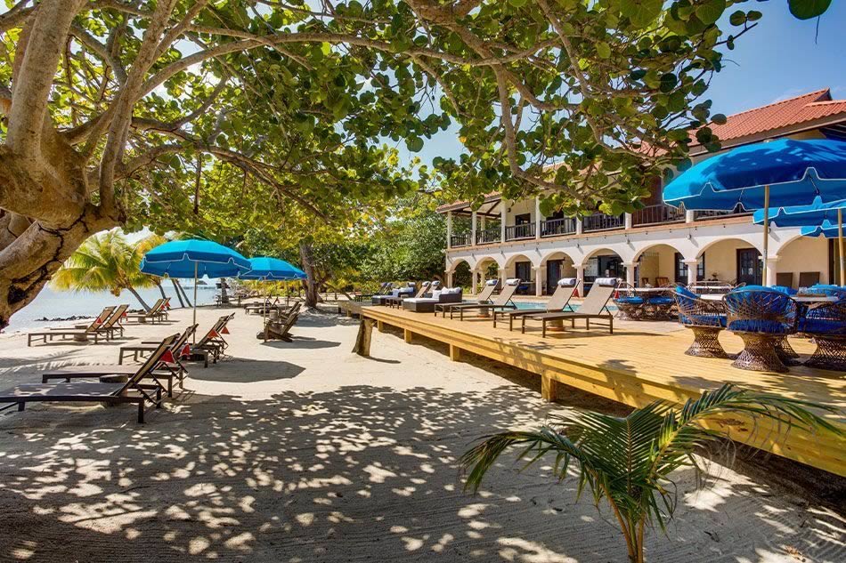View of Mariposa Resort beach deck with ombrellos