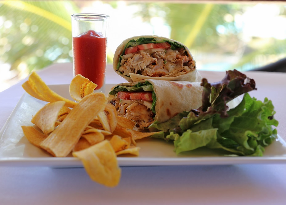 Tasty Burritos on table with chips and juice