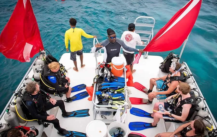Diving instructor talking to divers on a dive boat