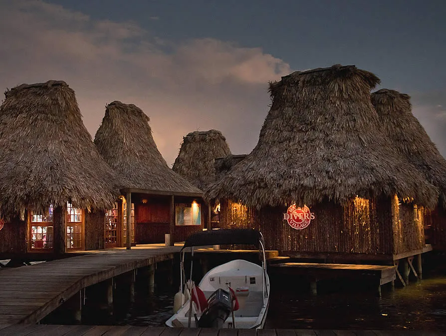 Pier with sheds and docked dive boats at night