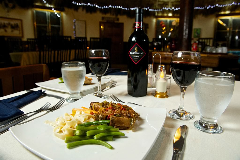 Table with fine wine and a gourmet dish