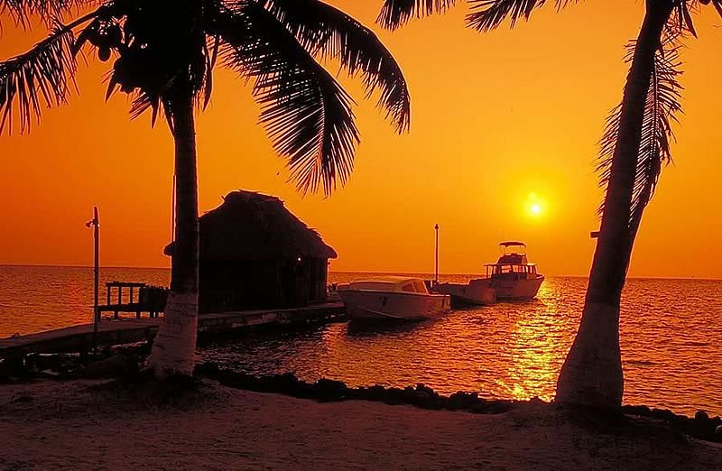 Sunset view from the pier at Blackbird Caye resort