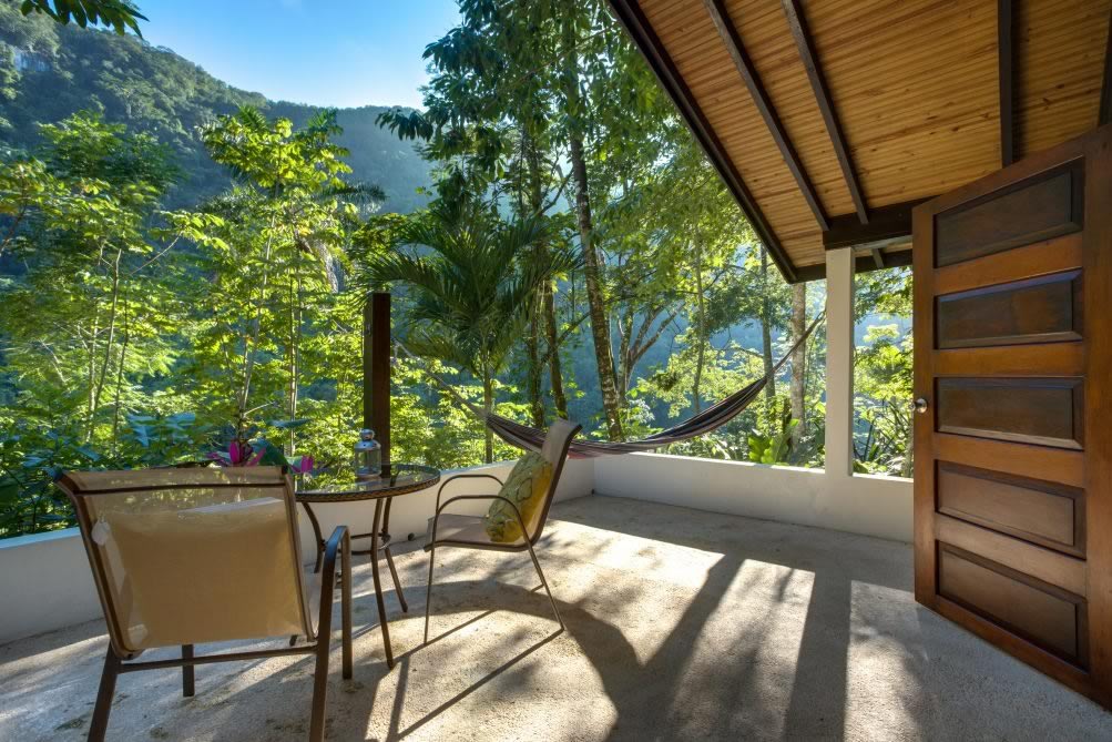 Exterior of a classic cabin tuck in a tropical garden