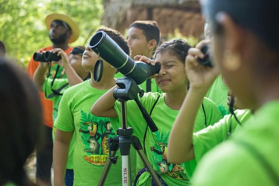 Kids with tripod binoculars bird watching