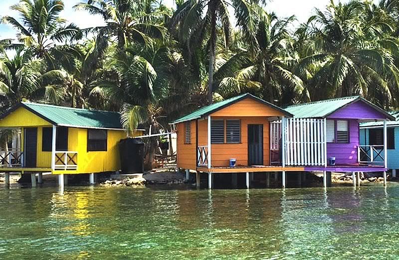The front of three overwater cabins facing the sea