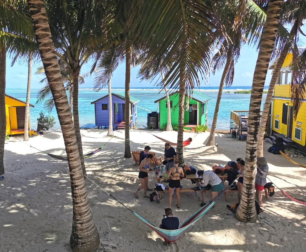 Guest at Tobacco Caye Paradise getting diving equipment ready