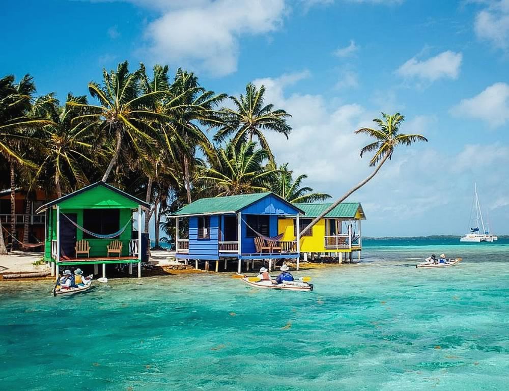 Two kayakers in front of Tobacco Caye