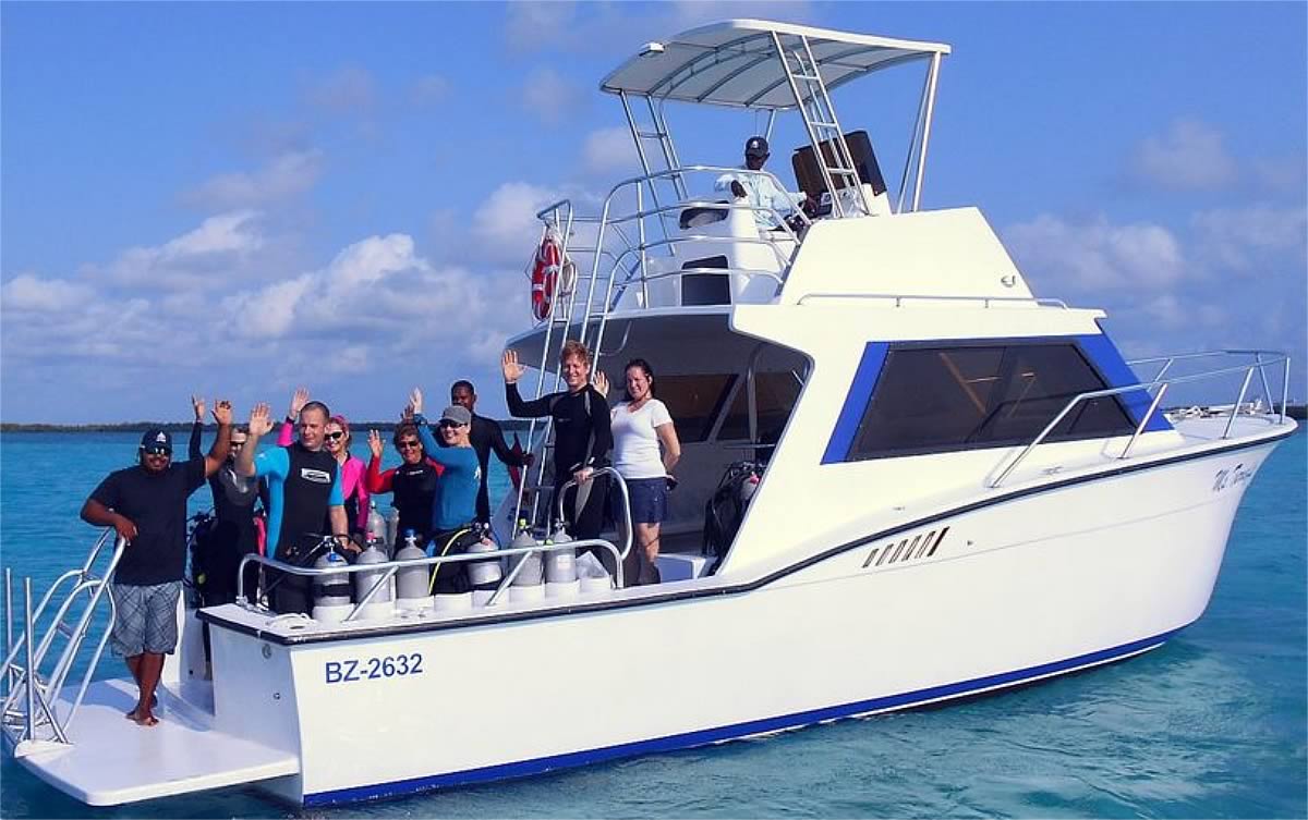 Dive crew on boat waving');