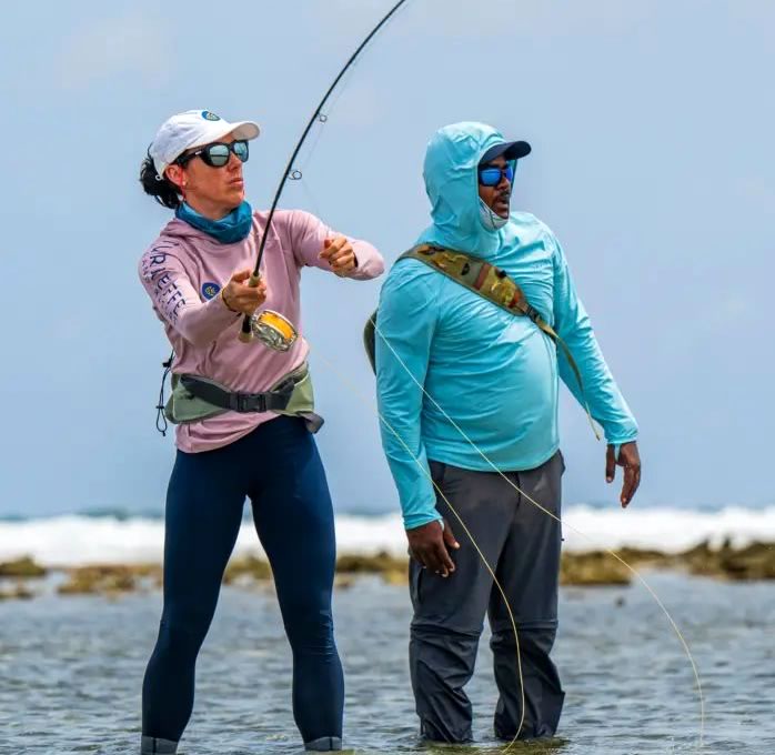 A fishing guide and woman fly fishing