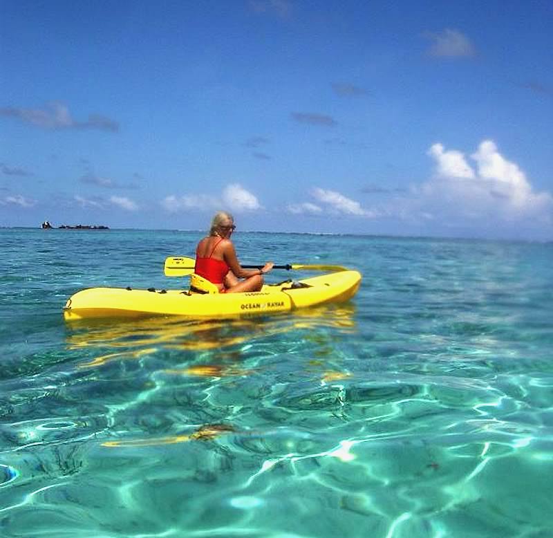 A woman in a kayak at Turneffe Atoll