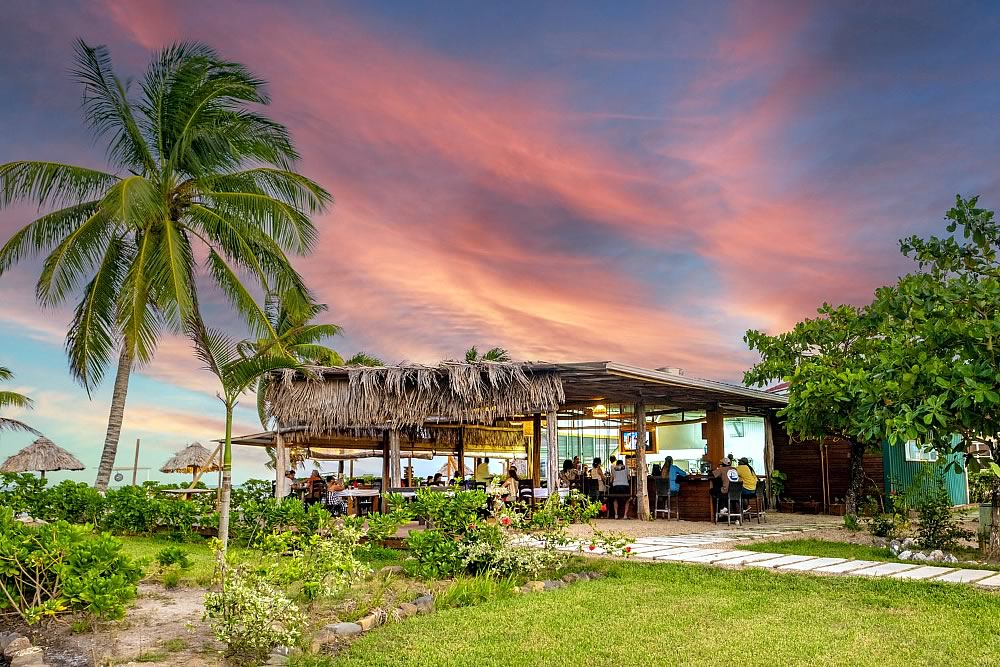 People socializing in the beach Rhum Shack at Hopkins Bay Resort
