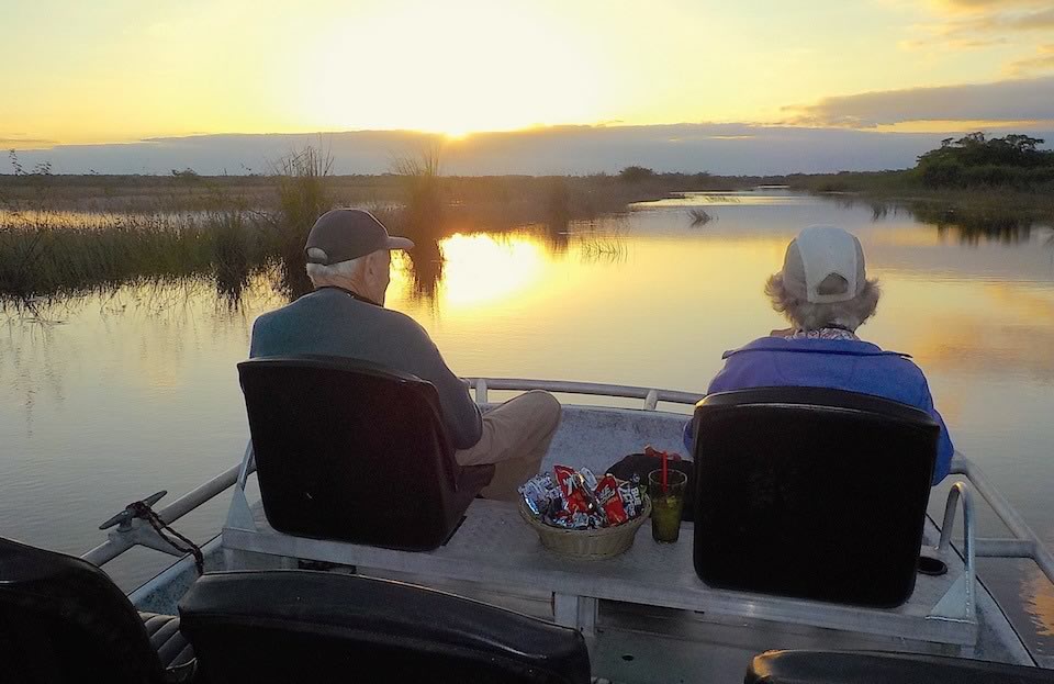 Two seniors enjoying the view on a sunset safari