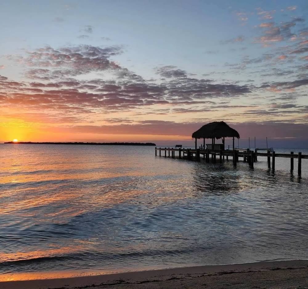 View of the sunset and offshore caye from Azura Del Mar pier