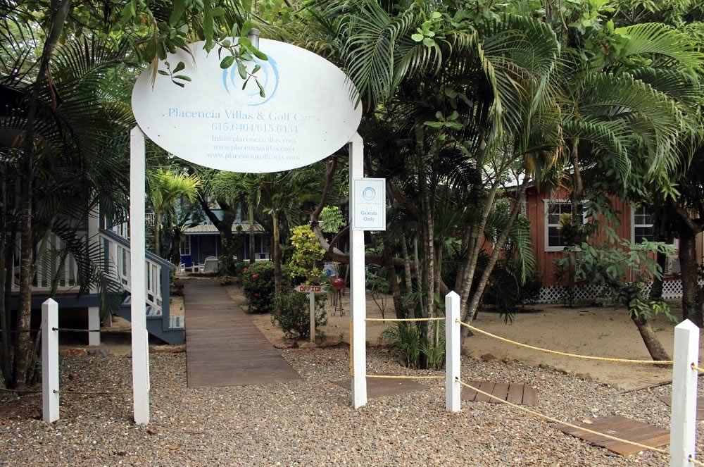 Entrance with name sign over the walkway at Placencia Villas