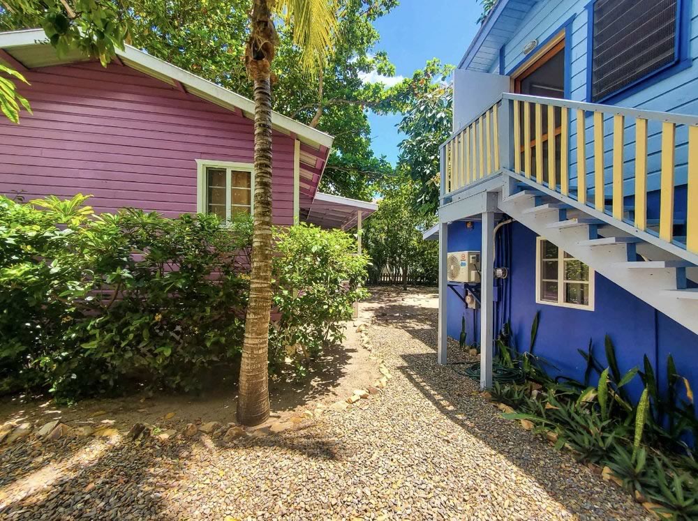 The pink painted villa in a natural garden setting at Placencia Villas