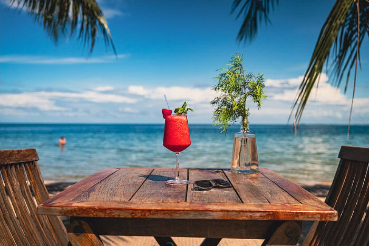 Beach table with a glass off cocktail