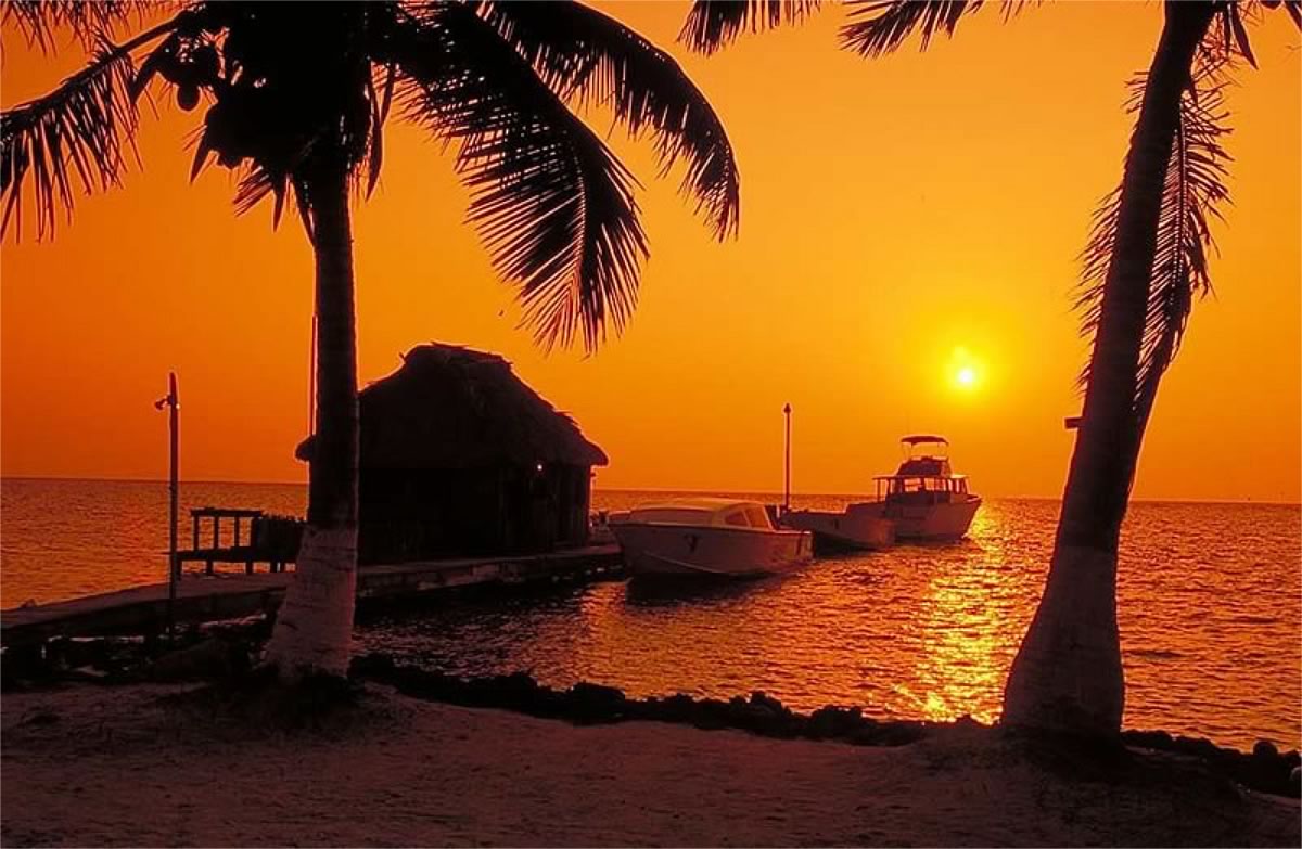 Sunset view from the pier at Blackbird Caye resort