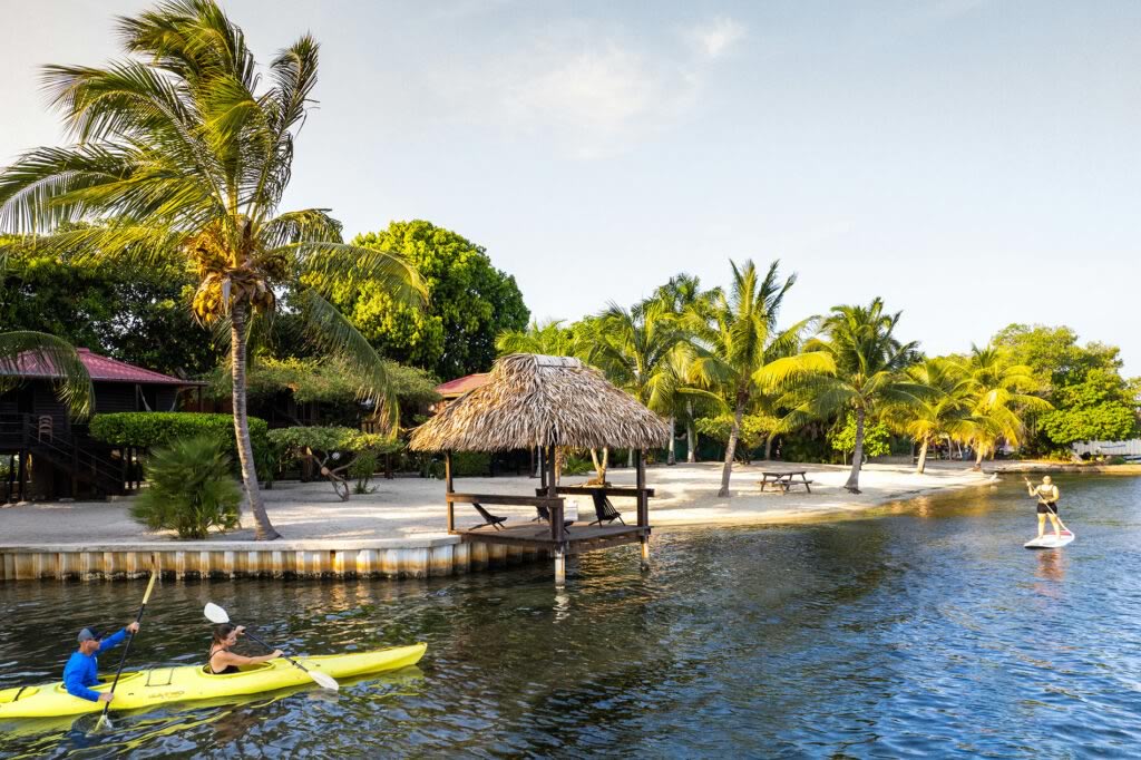 Two people in a kayak in front of Harry's Cabanas