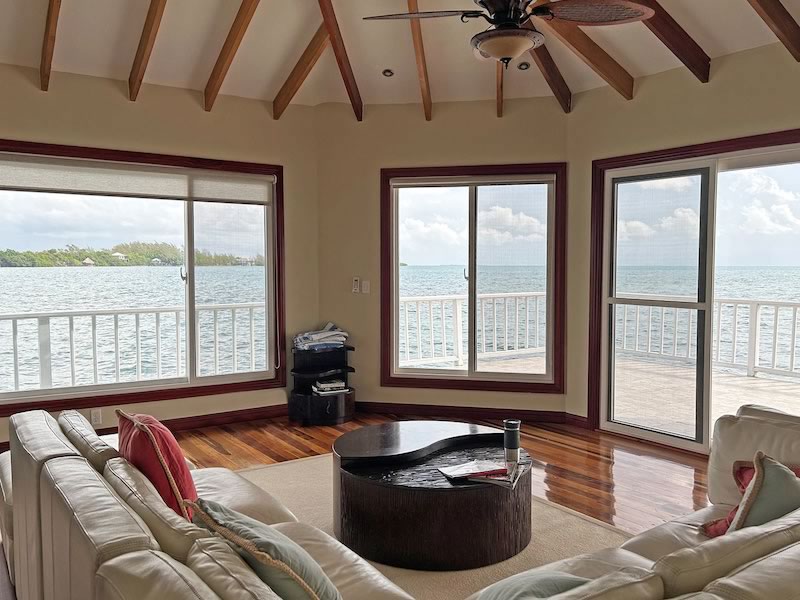 Interior of overwater villa living room with view of the ocean