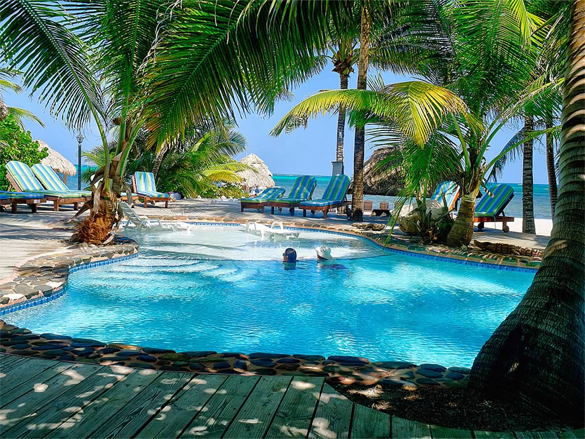 Woman in swimming pool with view Belize Barrier Reef