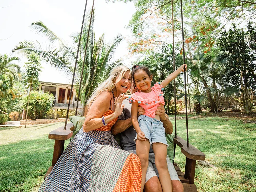 Family swinging on the grounds swing