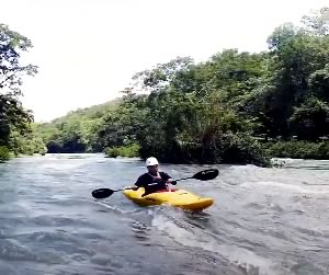 Kayaker on river rapids